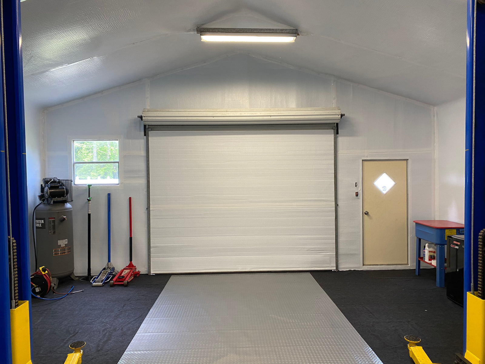 Commercial roll-up garage door (coiled drum above opening)