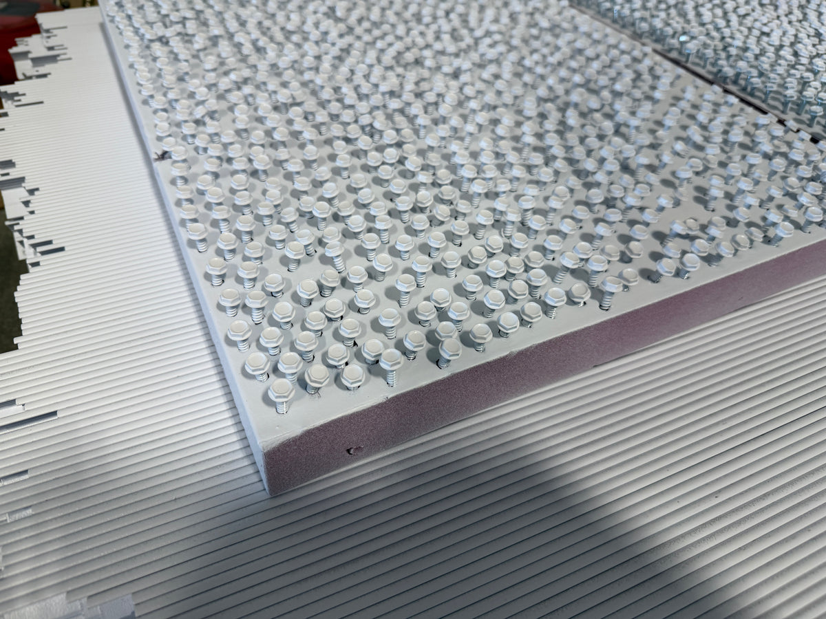 Screws were pre-painted white before install, so once the TermBars locked the BlueTex™ Insulation in place, no bare metal screw heads show against the white finish.