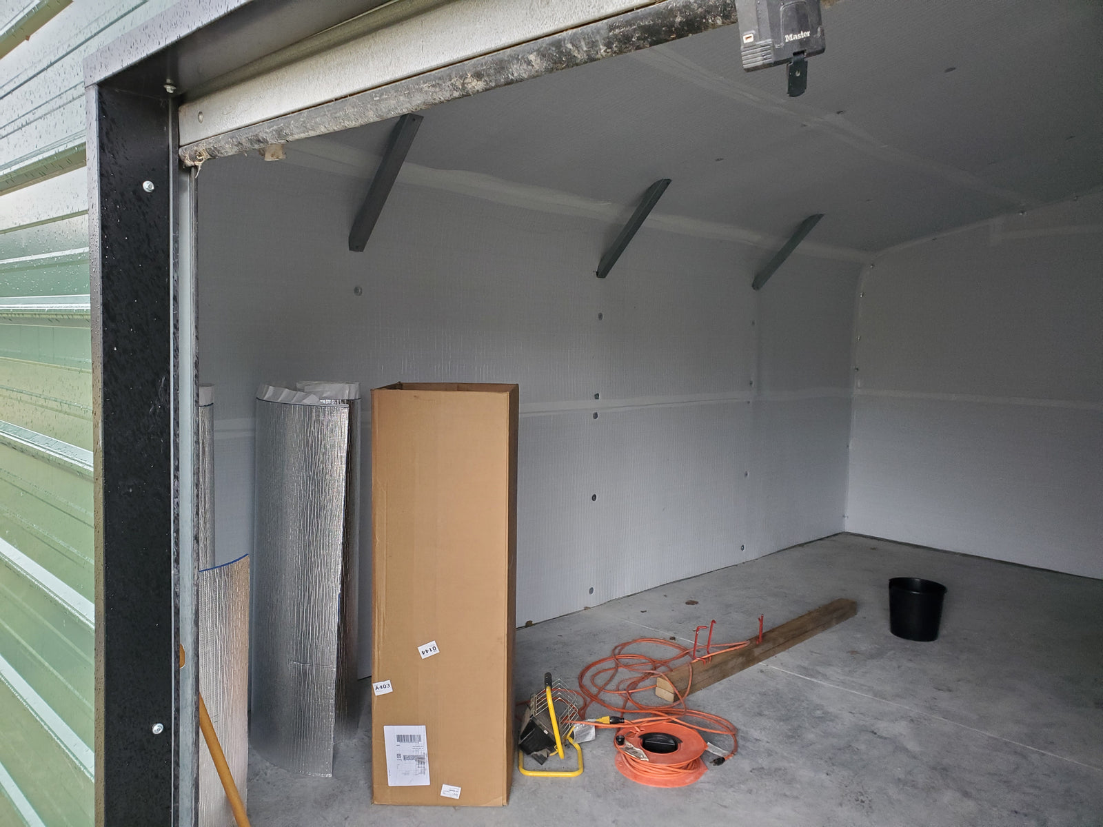 Close-up of BlueTex™ Insulation install on a tubular steel metal building wall