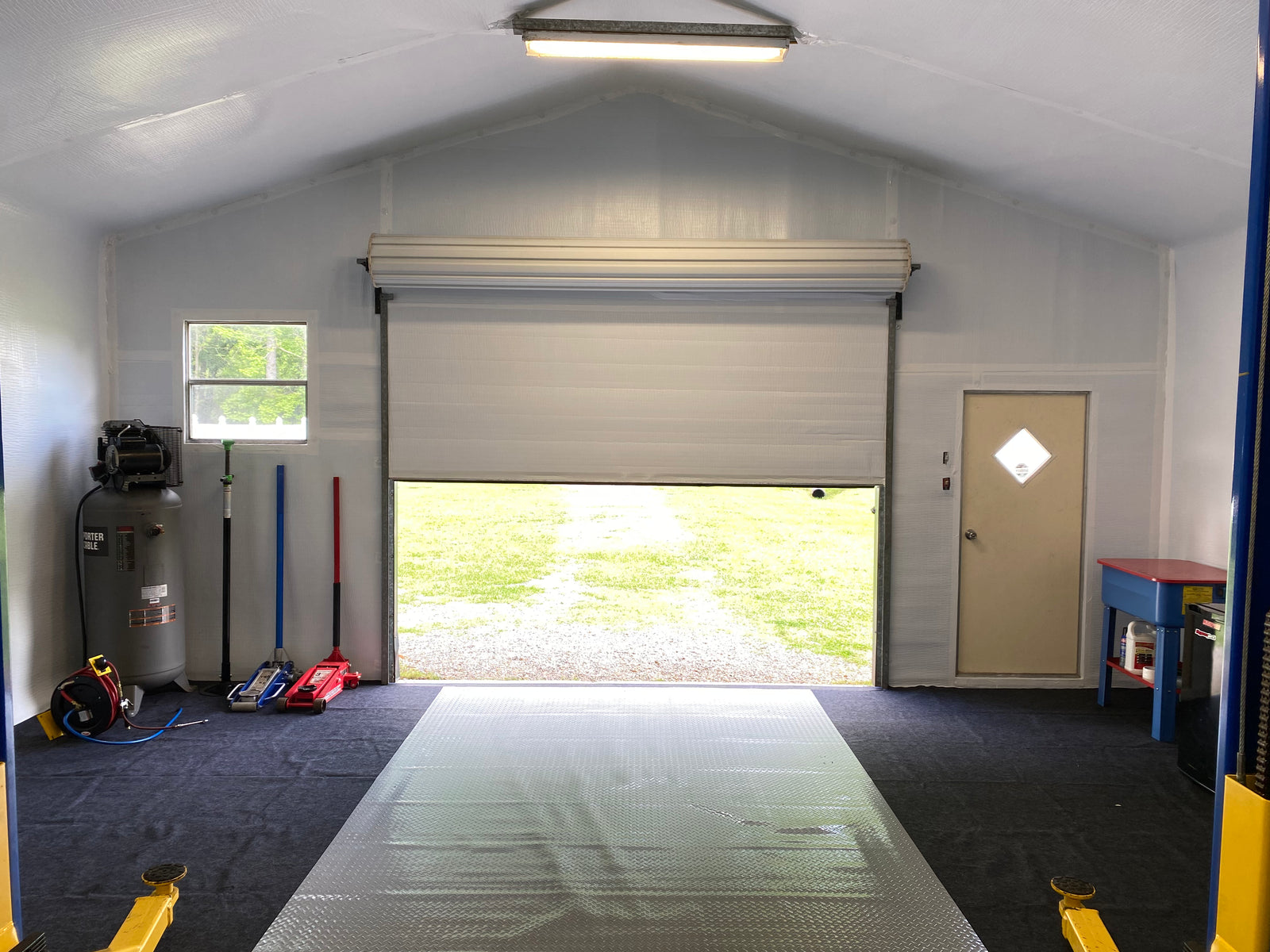 Commercial roll-up door installed in metal building - exterior view